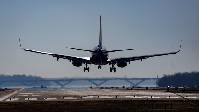 File - A Southwest plane lands at Ronald Reagan Washington National Airport in Arlington, Va., Friday, Dec. 30, 2022. The TSA said this week it is prepared to screen high volumes of summer passengers at airport security checkpoints. (AP Photo/Carolyn Kaster, File)
