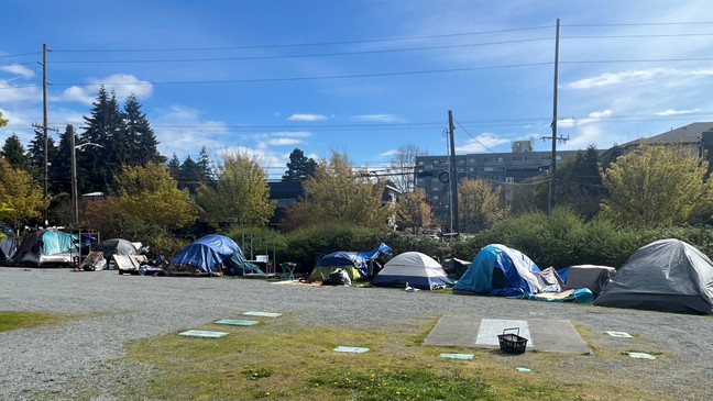A dozen or more tents line the eastern edge of Hubbard Homestead Park in Seattle's Northgate neighborhood on April 26, 2023. (KOMO News)