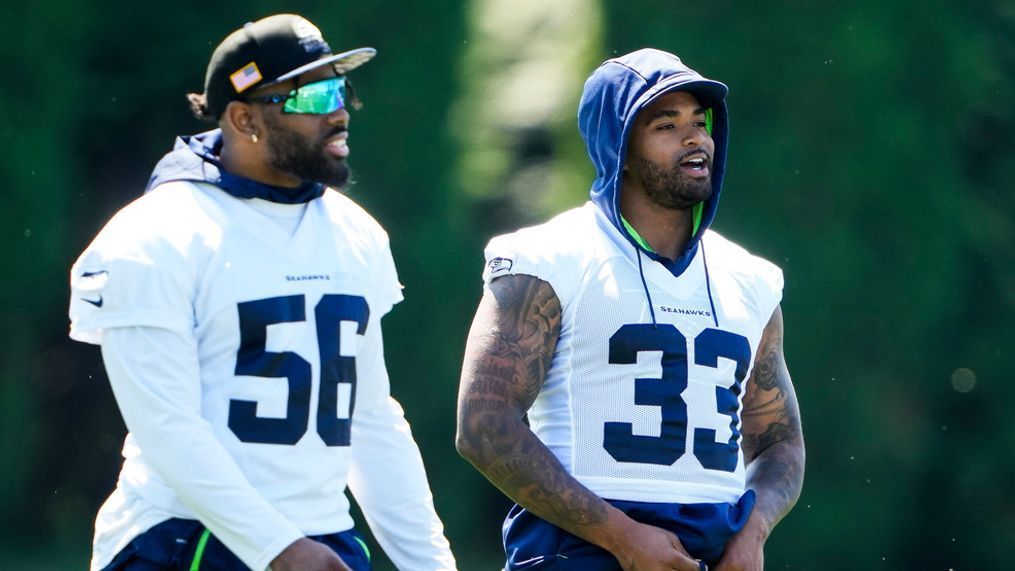 Seattle Seahawks linebacker Jordyn Brooks (56) and safety Jamal Adams (33) talk during NFL football practice, Tuesday, June 6, 2023, at the team's facilities in Renton, Wash. (AP Photo/Lindsey Wasson)