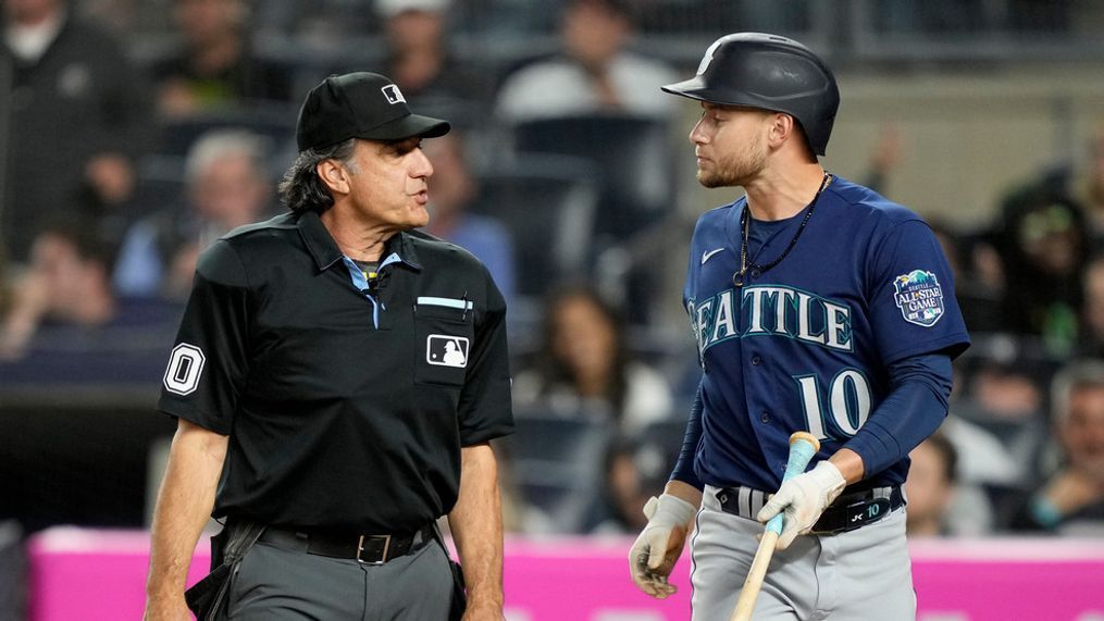 Seattle Mariners' Jarred Kelenic (10) argues balls and strikes with umpire Phil Cuzzi, left, in the seventh inning of a baseball game, Wednesday, June 21, 2023, in New York. (AP Photo/John Minchillo)