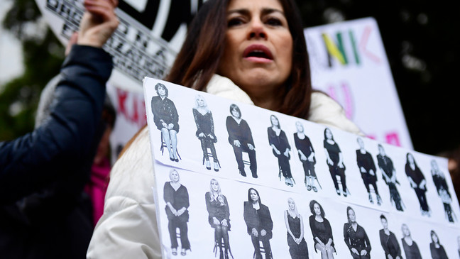 FILE - In this Monday, April 9, 2018 file photo, Sonia Ossorio, center, president of the National Organization for Women of New York, leads a protest after Bill Cosby arrived for his sexual assault trial at the Montgomery County Courthouse in Norristown, Pa. (AP Photo/Corey Perrine, File)