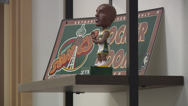 In this photo is a Gary Payton SuperSonics bobblehead at sports retail "Simply Seattle." (KOMO)