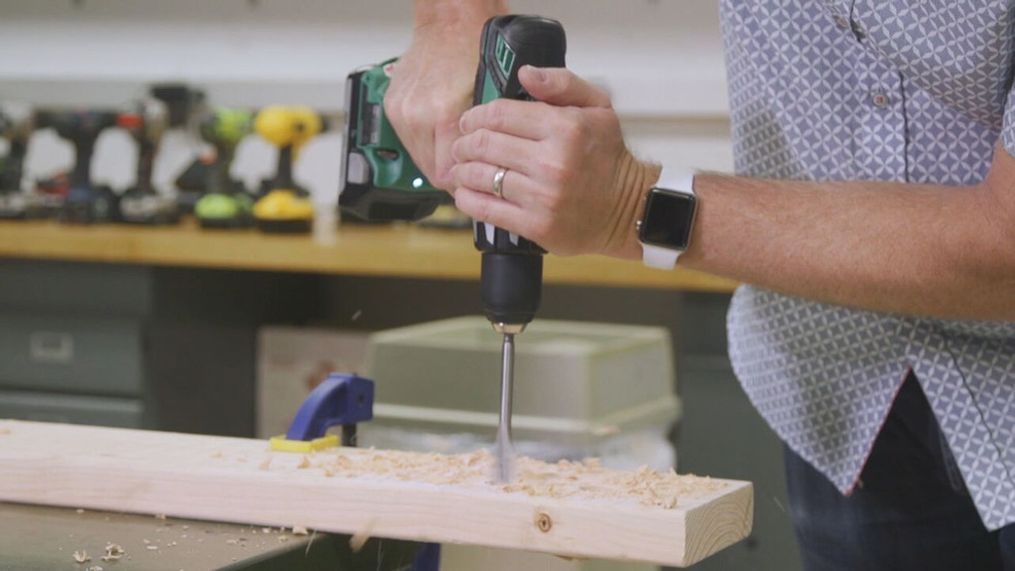A man uses a cordless drill while wearing an Apple Watch. (Photo: KOMO News via Consumer Reports)