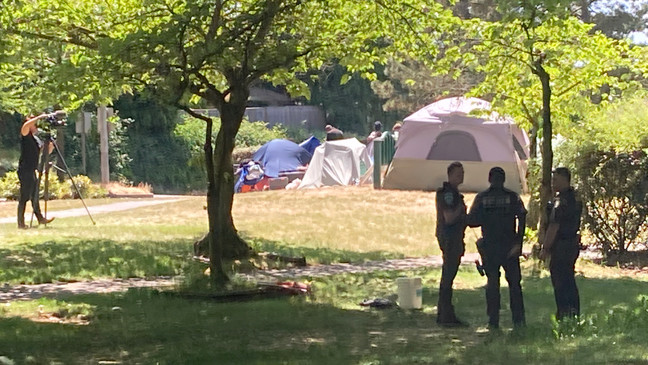 Police in Burien wait for people who pitched tents in Dottie Harper Park to pack up and move on Tuesday.{&nbsp;} (KOMO News)