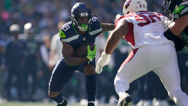 Seattle Seahawks running back Kenneth Walker III (9) runs against Arizona Cardinals defensive tackle Rashard Lawrence (90) during the first half of an NFL football game in Seattle, Sunday, Oct. 16, 2022. (AP Photo/Abbie Parr)
