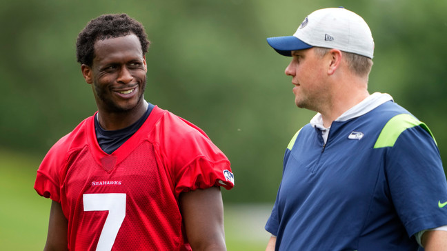 Seattle Seahawks quarterback Geno Smith (7) smiles with Seahawks offensive coordinator Shane Waldron, right, Monday, May 22, 2023, at the team's NFL football training facility in Renton, Wash. (AP Photo/Lindsey Wasson)
