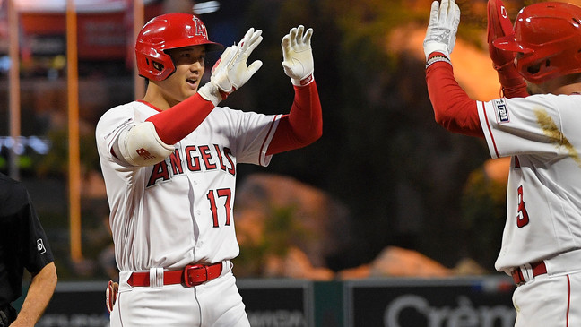 Los Angeles Angels' Shohei Ohtani, left, is congratulated by Zach Neto after hitting a two-run home run during the third inning of a baseball game against the Seattle Mariners Saturday, June 10, 2023, in Anaheim, Calif. (AP Photo/Mark J. Terrill)