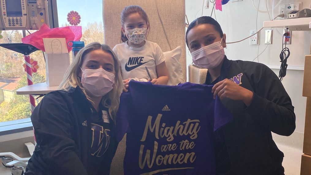 The University of Washington softball team visited patients at Seattle Children's on March 22 and designed cleats together. (Photo courtesy of Seattle Children's)