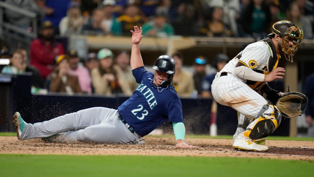Seattle Mariners' Ty France (23) scores from second base off a single by Teoscar Hernandez as San Diego Padres catcher Austin Nola waits for the throw during the eighth inning of a baseball game Tuesday, June 6, 2023, in San Diego. (AP Photo/Gregory Bull)