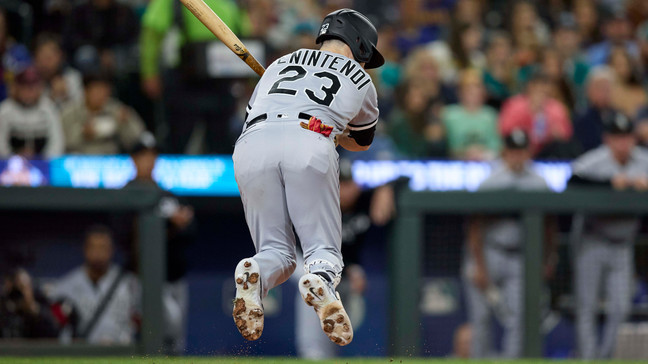 Chicago White Sox's Andrew Benintendi jumps from an inside pitch from Seattle Mariners' Bryan Woo during the fourth inning of a baseball game Friday, June 16, 2023, in Seattle. (AP Photo/John Froschauer)