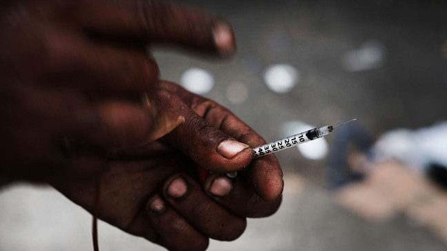 FILE - A heroin user displays a needle. (Photo by Spencer Platt/Getty Images)