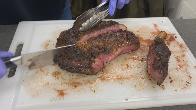 A person cuts a ribeye steak in a kitchen. (Photo: KOMO News via Consumer Reports)