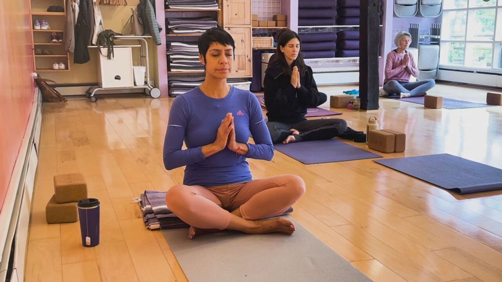File – A group of women meditate during a yoga class. Yoga - which blends movements and poses with deep breathing, meditation, and stretching - has many potential health and physical benefits that can help you fight back against chronic pain. (Photo: KOMO News via Consumer Reports)