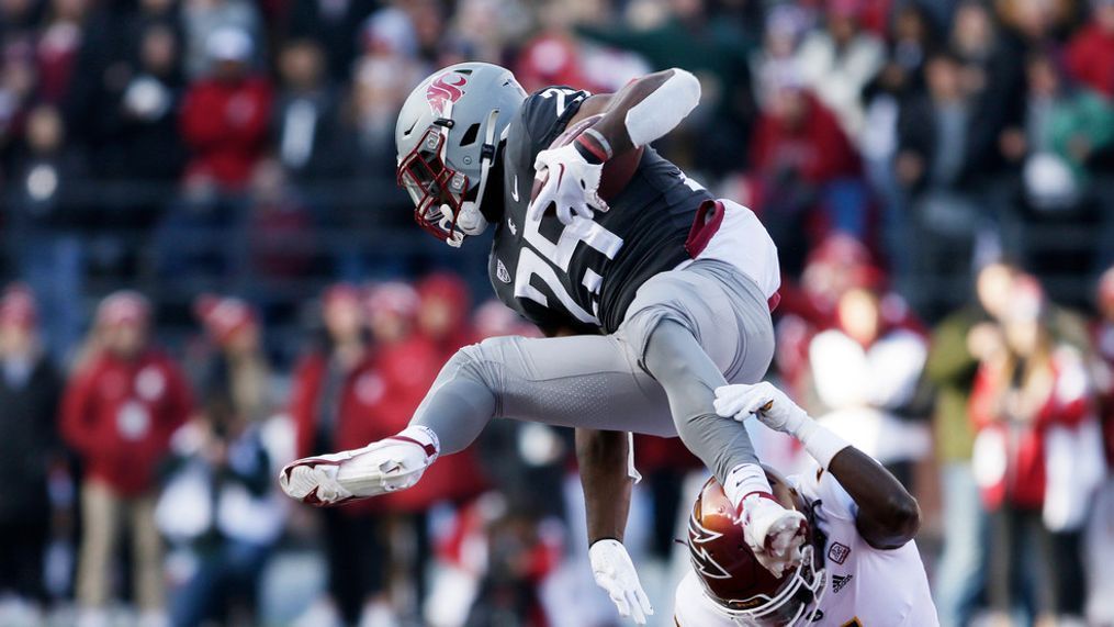 Washington State running back Nakia Watson (25) leaps and is tripped up by Arizona State defensive back Chris Edmonds (5) during the first half of an NCAA college football game, Saturday, Nov. 12, 2022, in Pullman, Wash. (AP Photo/Young Kwak)