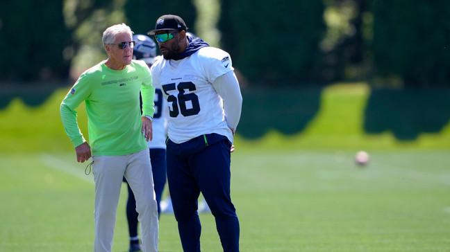 Seattle Seahawks coach Pete Carroll talks with linebacker Jordyn Brooks (56) during minicamp Tuesday, June 6, 2023, at the NFL football team's facilities in Renton, Wash. (AP Photo/Lindsey Wasson)
