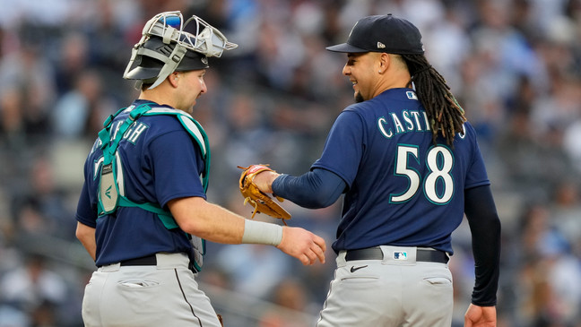 Seattle Mariners starting pitcher Luis Castillo (58) meets with catcher Cal Raleigh (29) on the mound after giving up a two-run home run to New York Yankees' Jake Bauers in the third inning of a baseball game, Wednesday, June 21, 2023, in New York. (AP Photo/John Minchillo)