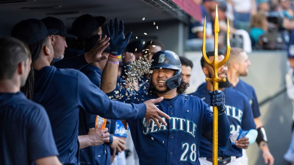 Seattle Mariners' Eugenio Suarez (28) is congratulated by teammates in the dugout after hitting a solo home run off Miami Marlins relief pitcher Huascar Brazoban during the fifth inning of a baseball game, Monday, June 12, 2023, in Seattle. (AP Photo/Stephen Brashear)